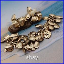 1982 Napier Clam Shell Gold Tone Loaded Charm 7 1/2 Bracelet Clip Earring Set