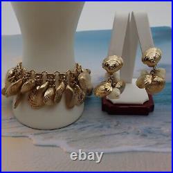 1982 Napier Clam Shell Gold Tone Loaded Charm 7 1/2 Bracelet Clip Earring Set