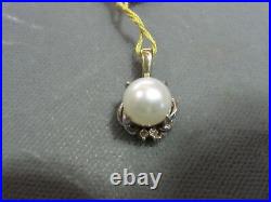 5 mm Round Pearl and 4 Brilliant Cut Diamonds Set in 14kt White Gold Pendant