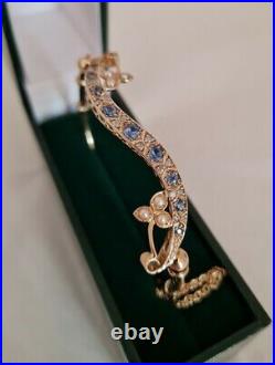 9ct Yellow Gold bangle. Set with Corn flower blue Sapphires, Diamonds & Pearls