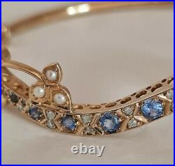 9ct Yellow Gold bangle. Set with Corn flower blue Sapphires, Diamonds & Pearls