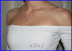 A cultured pearl set pendant on chain in 18ct yellow gold