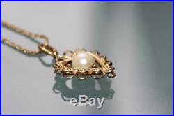 A cultured pearl set pendant on chain in 18ct yellow gold