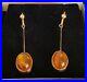 An-antique-pair-of-9ct-Yellow-gold-drop-earrings-Set-with-oval-Baltic-Amber-01-zkj