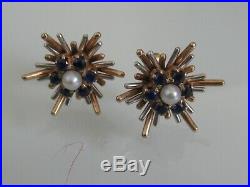 Pair of 9ct yellow and white gold earrings set with single central pearl surroun