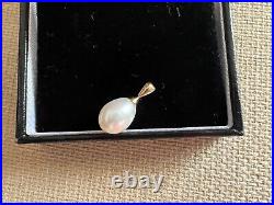 Pear shaped white pearl set in 14 carat yellow gold